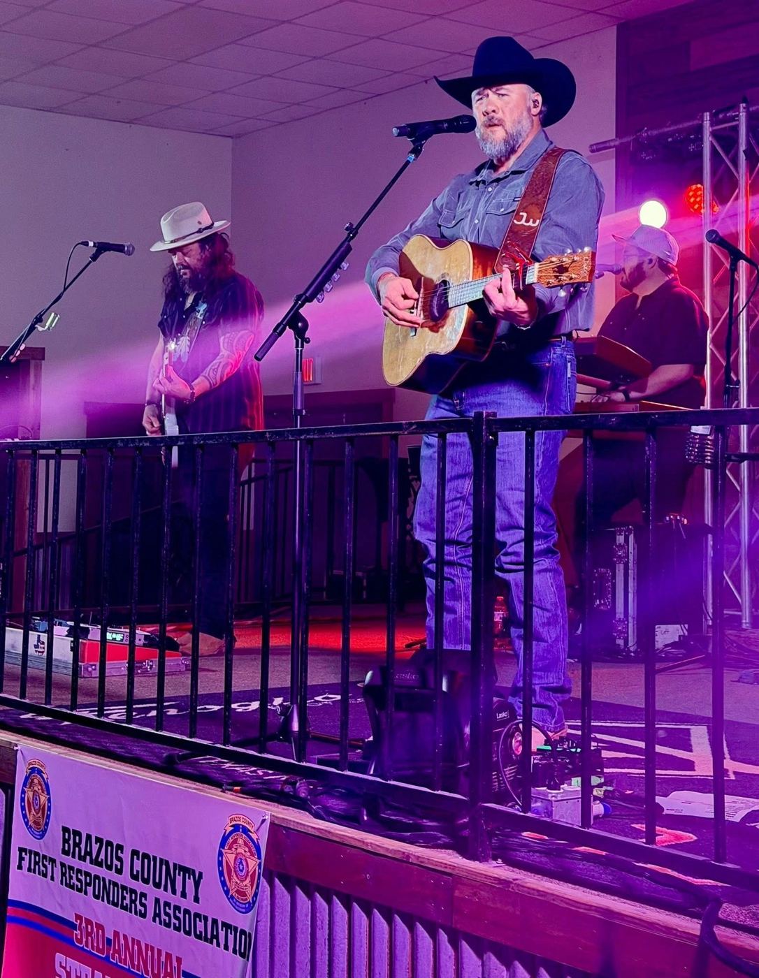 Singer with acoustic guitar on stage
